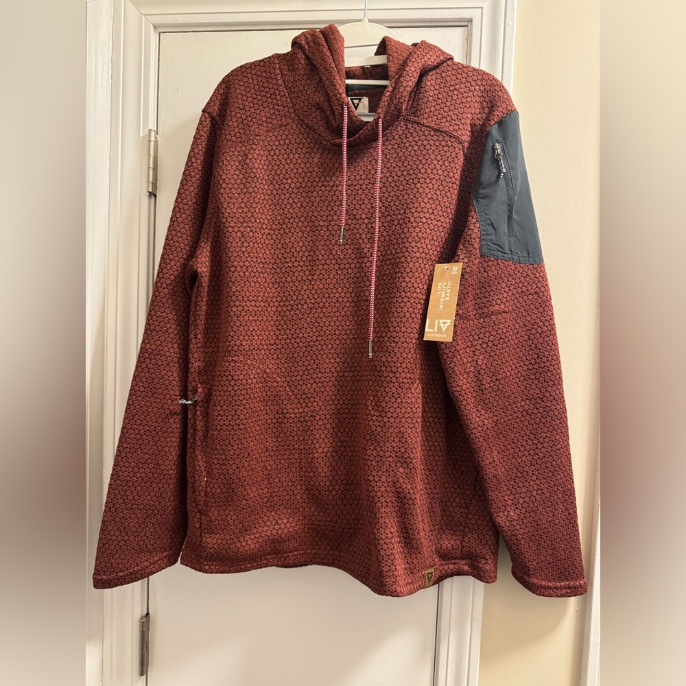 NWT Burgundy and black pull over.  Zipper sleeve pocket and zipper side pockets